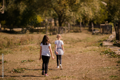 Little girls on the old farm. Autumn time