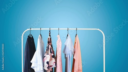 Women's clothing on a white clothes hanger on blue pastel background. photo