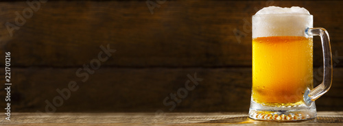 mug of beer on wooden table
