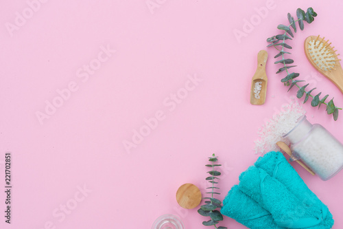 Beauty background with a natural soap, cream, towels and cotton buds on pink, falt lay with copy space photo