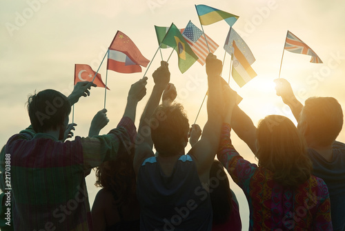 Obraz na płótnie Crowd of people rising up country flags