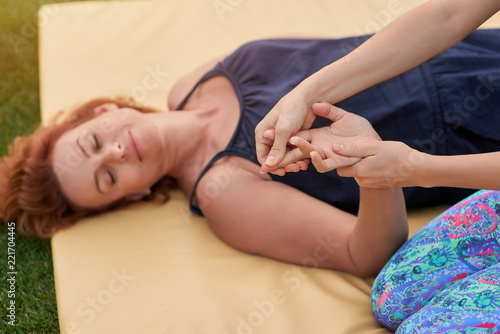 Close up hand massaging. Women hands. Lying with closed eyes.
