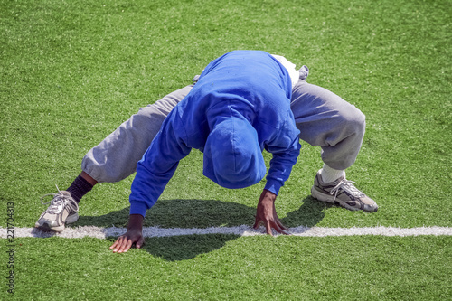 Track and field athlete stretching