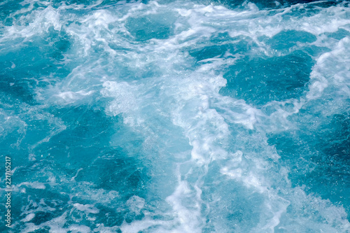 Troubled blue sea water with white foam, abstract nature background concept © JethroT