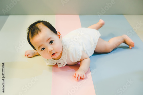 Asian baby girl lying on the bed, Baby development.