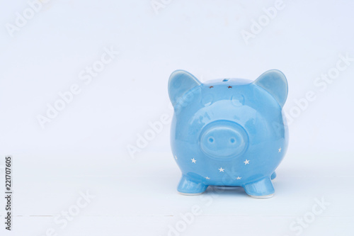 Blue piggy bank on white background, savings concept
