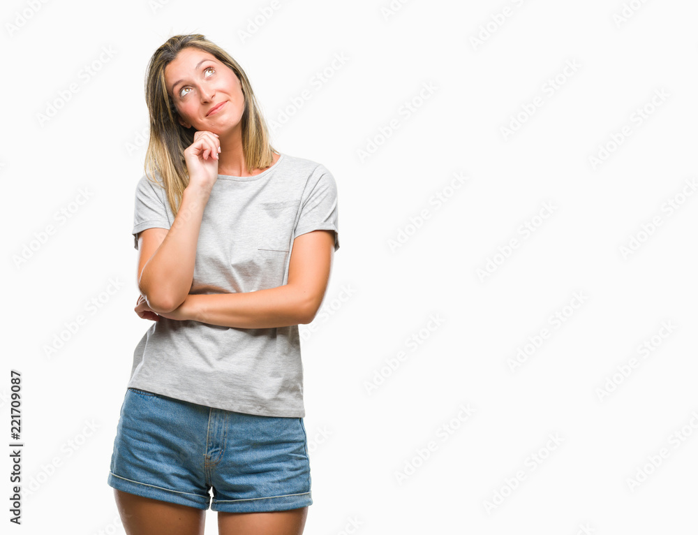 Young beautiful woman over isolated background with hand on chin thinking about question, pensive expression. Smiling with thoughtful face. Doubt concept. Young beautiful woman over isolated background with hand on chin thinking about question, pensive expression. Smiling with thoughtful face. Doubt concept.