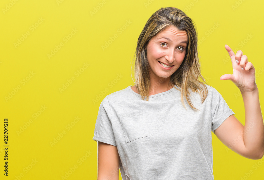 Young beautiful woman over isolated background smiling and confident gesturing with hand doing size sign with fingers while looking and the camera. Measure concept. Young beautiful woman over isolated background smiling and confident gesturing with hand doing size sign with fingers while looking and the camera. Measure concept.