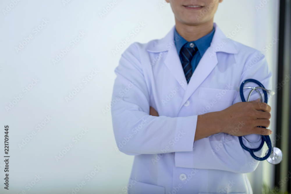 Portrait of doctor standing in his private clinic. Medical physician doctor man over clinic background. Doctor. Portrait of doctor standing in his private clinic. Medical physician doctor man over clinic background. Doctor.