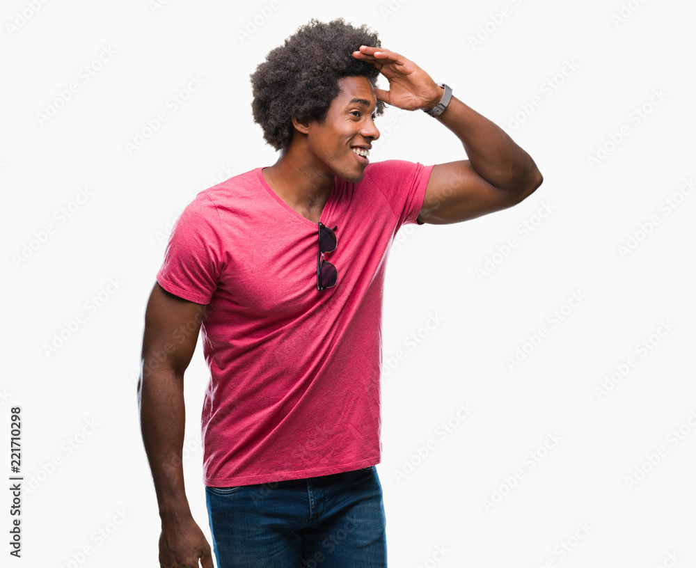 Afro american man over isolated background very happy and smiling looking far away with hand over head. Searching concept. Afro american man over isolated background very happy and smiling looking far away with hand over head. Searching concept.