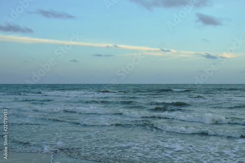 landscape of sea and water surf to beach in sunset