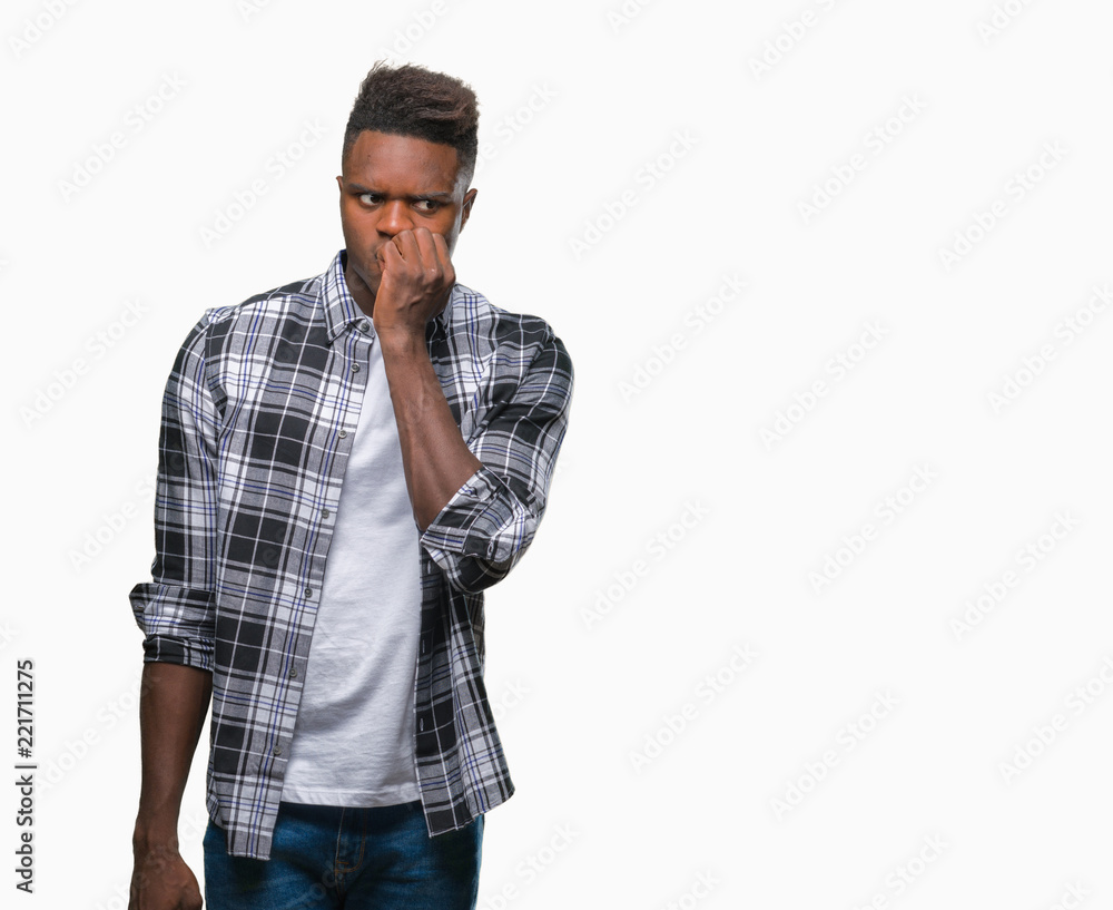 Young african american man over isolated background looking stressed and nervous with hands on mouth biting nails. Anxiety problem. Young african american man over isolated background looking stressed and nervous with hands on mouth biting nails. Anxiety problem.