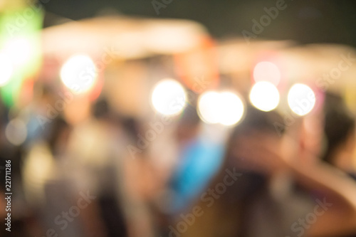 abstract blur image of food stall at night festival with bokeh for background usage
