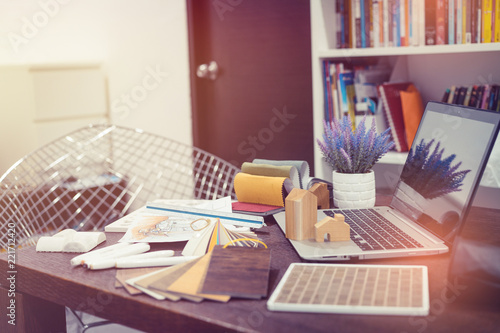 Wallpaper Mural colleagues interior designers discussing data with new modern computer laptop .Top view of architects hands drawing of modern house with material sample . Torontodigital.ca
