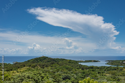 Cumulonimbus Anvil Cloud Over Caribbean Sea and Green Landscape Foreground