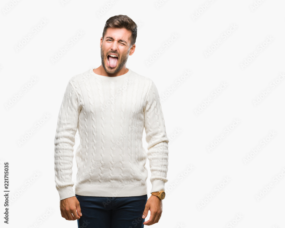 Young handsome man wearing winter sweater over isolated background sticking tongue out happy with funny expression. Emotion concept. Young handsome man wearing winter sweater over isolated background sticking tongue out happy with funny expression. Emotion concept.