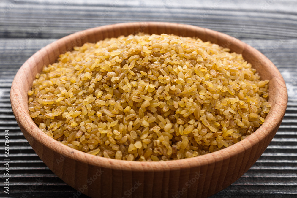 raw bulgur on a rustic wooden background raw bulgur on a rustic wooden background