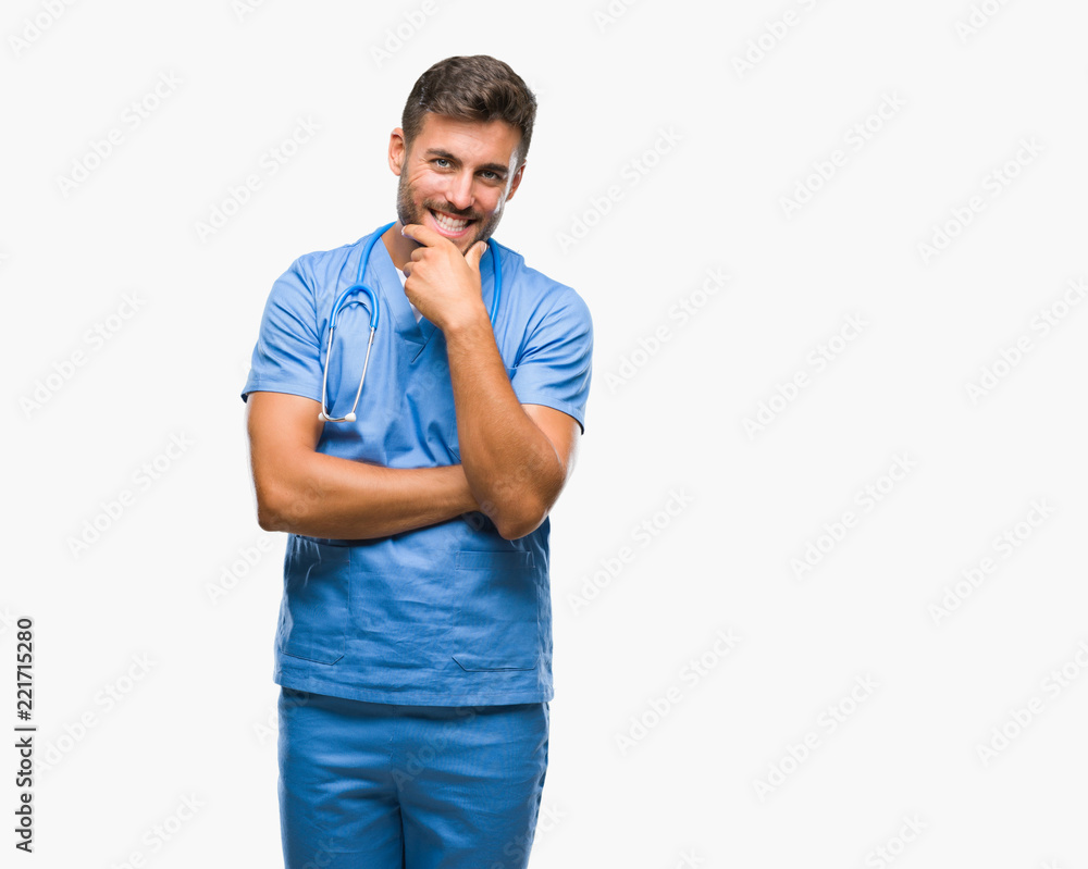 Young handsome doctor surgeon man over isolated background looking confident at the camera with smile with crossed arms and hand raised on chin. Thinking positive. Young handsome doctor surgeon man over isolated background looking confident at the camera with smile with crossed arms and hand raised on chin. Thinking positive.
