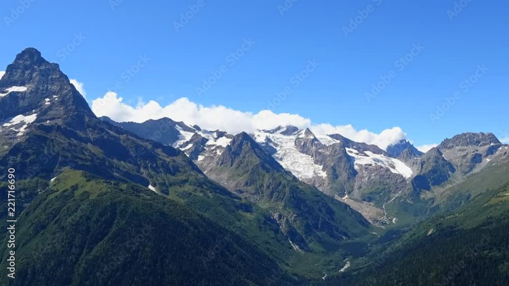 Time lapse mountains scenes in national park Dombai, Caucasus, Russia, Europe. Summer landscape, sunshine weather, blue sky and sunny day Time lapse mountains scenes in national park Dombai, Caucasus, Russia, Europe. Summer landscape, sunshine weather, blue sky and sunny day