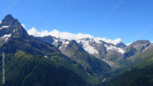 Wallpaper Mural Time lapse mountains scenes in national park Dombai, Caucasus, Russia, Europe. Summer landscape, sunshine weather, blue sky and sunny day Torontodigital.ca