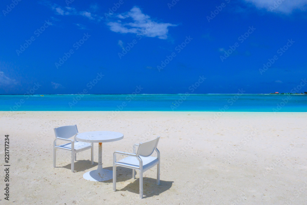 Table and chair on the white sandy beach