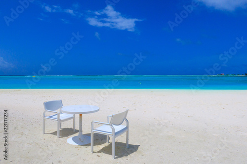 Table and chair on the white sandy beach © shadowbird