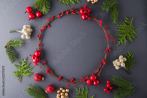 Christmas wreath on dark background top view. Merry christmas greeting card, banner. Winter xmas holiday theme. Happy New Year. Space for text. Flat lay.