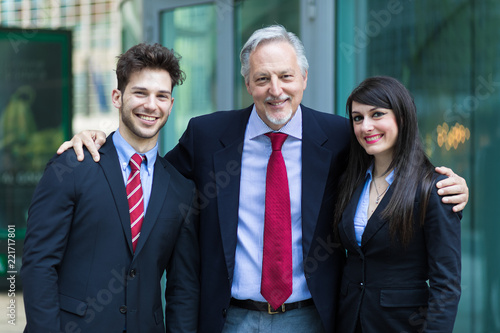 Business team smiling outdoor in a modern urban setting