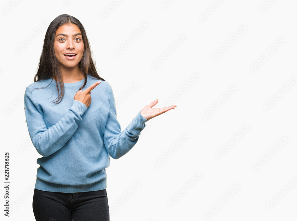 Young arab woman pointing to hand over isolated background Young arab woman pointing to hand over isolated background