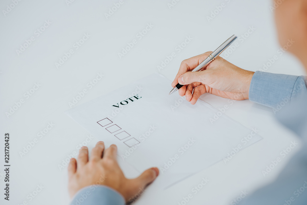 Hand trying to vote in paper Hand trying to vote in paper