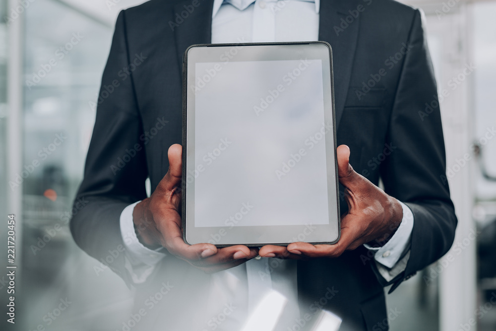 Check this out. Close up of male hands holding table, while standing in the office Check this out. Close up of male hands holding table, while standing in the office