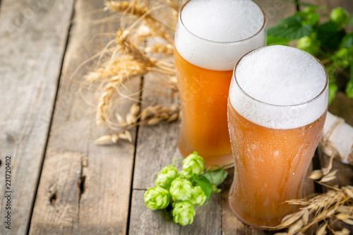 Beer and ingredients hops, wheat, barley on wood background, copy space photo
