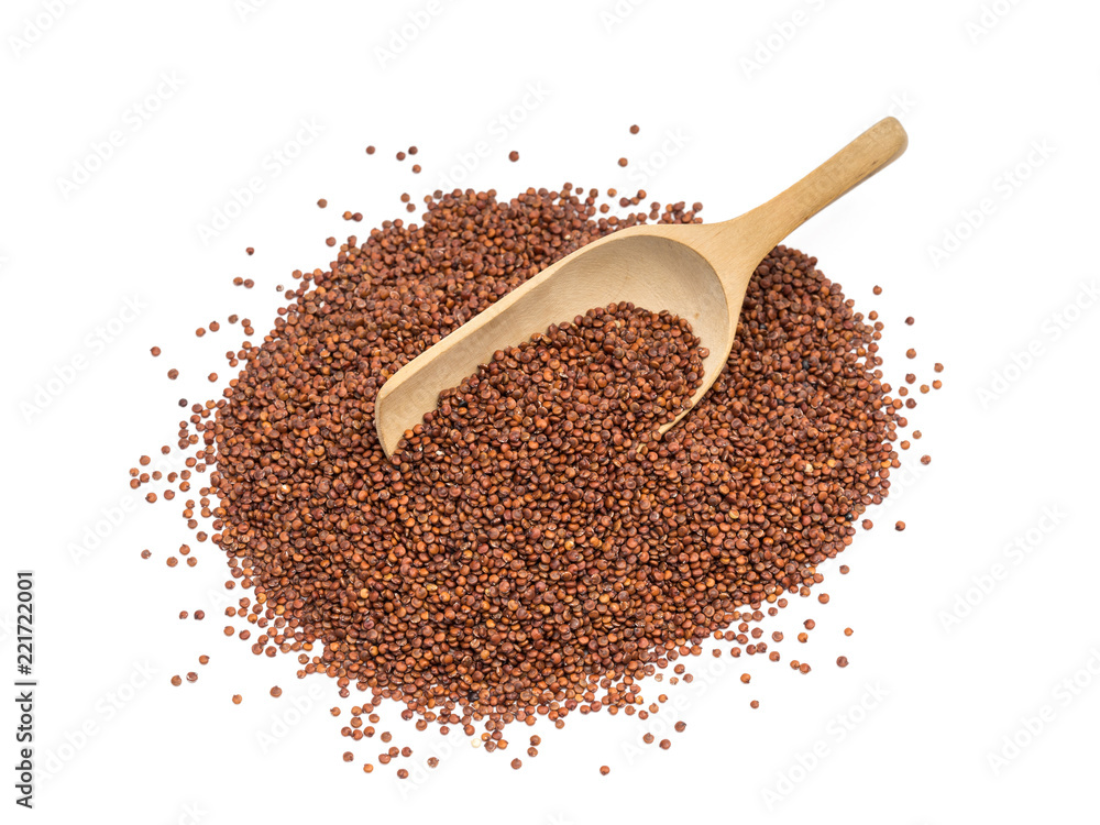 Pile of red quinoa seeds with a wooden spoon in it seen obliquely from above and isolated on white background Pile of red quinoa seeds with a wooden spoon in it seen obliquely from above and isolated on white background