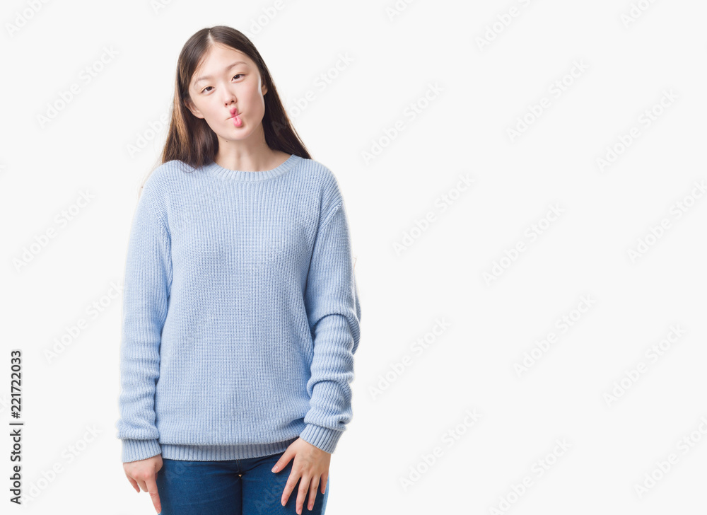 Young Chinese woman over isolated background making fish face with lips, crazy and comical gesture. Funny expression. Young Chinese woman over isolated background making fish face with lips, crazy and comical gesture. Funny expression.