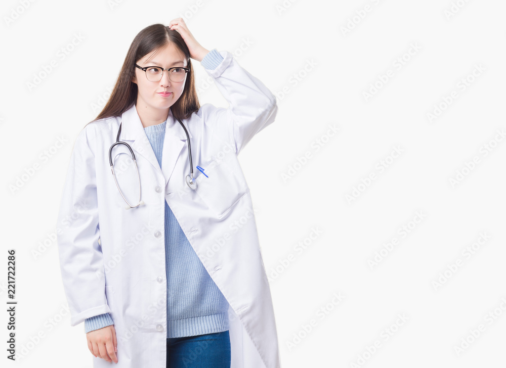 Young Chinese doctor woman over isolated background confuse and wonder about question. Uncertain with doubt, thinking with hand on head. Pensive concept. Young Chinese doctor woman over isolated background confuse and wonder about question. Uncertain with doubt, thinking with hand on head. Pensive concept.