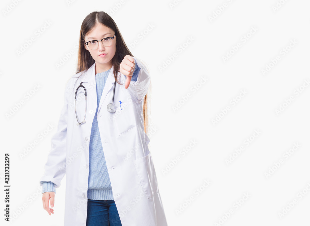 Young Chinese doctor woman over isolated background looking unhappy and angry showing rejection and negative with thumbs down gesture. Bad expression. Young Chinese doctor woman over isolated background looking unhappy and angry showing rejection and negative with thumbs down gesture. Bad expression.