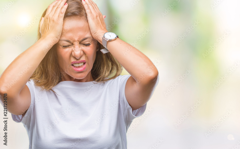 Middle age senior hispanic woman over isolated background suffering from headache desperate and stressed because pain and migraine. Hands on head. Middle age senior hispanic woman over isolated background suffering from headache desperate and stressed because pain and migraine. Hands on head.