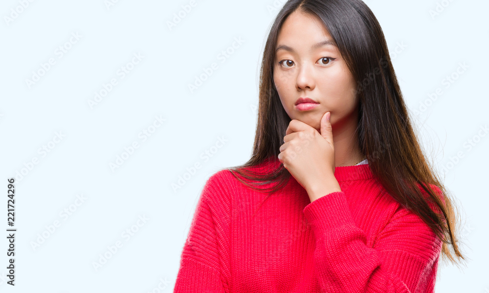 Young asian woman wearing winter sweater over isolated background looking confident at the camera with smile with crossed arms and hand raised on chin. Thinking positive. Young asian woman wearing winter sweater over isolated background looking confident at the camera with smile with crossed arms and hand raised on chin. Thinking positive.