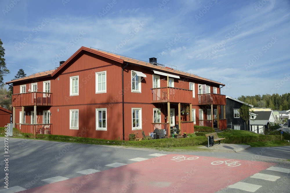 Scandinavian housing, classic red villa with blue sky Scandinavian housing, classic red villa with blue sky