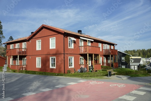 Fototapeta Naklejka Na Ścianę i Meble -  Scandinavian housing, classic red villa with blue sky