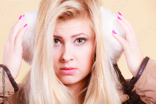 Blonde woman in winter warm earmuffs