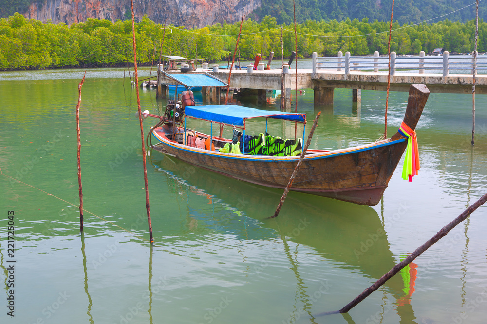 fishing boat or thai long tail boat on the beautiful color of water