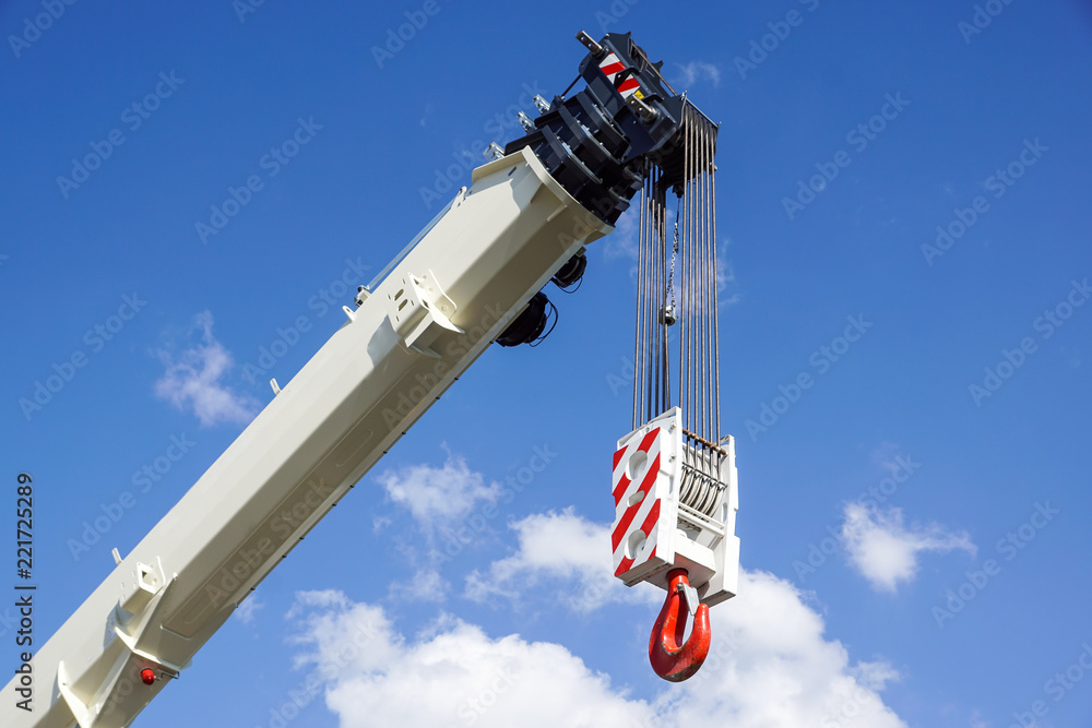 Boom of mobile crane with blue sky background.