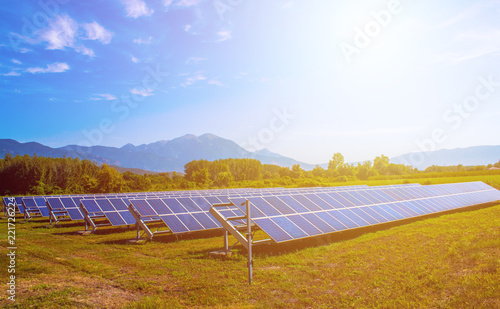 solar panels in field surrounded by mountains