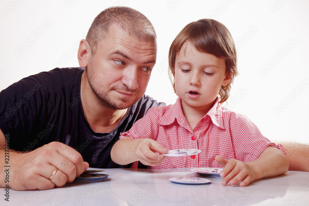 Father having fun with little daughter and playing board game. Father having fun with little daughter and playing board game.