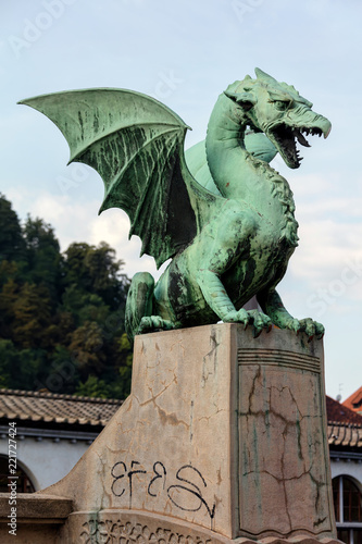 Dragon statue on the Dragon Bridge in Ljubljana, Slovenia. The bridge, decorated with the Dragon statues at four corners, was built in 1901 and since then has become a symbol of the city.