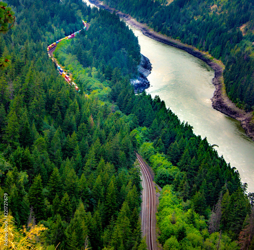 Train Runs Through the Canyon beside the River
