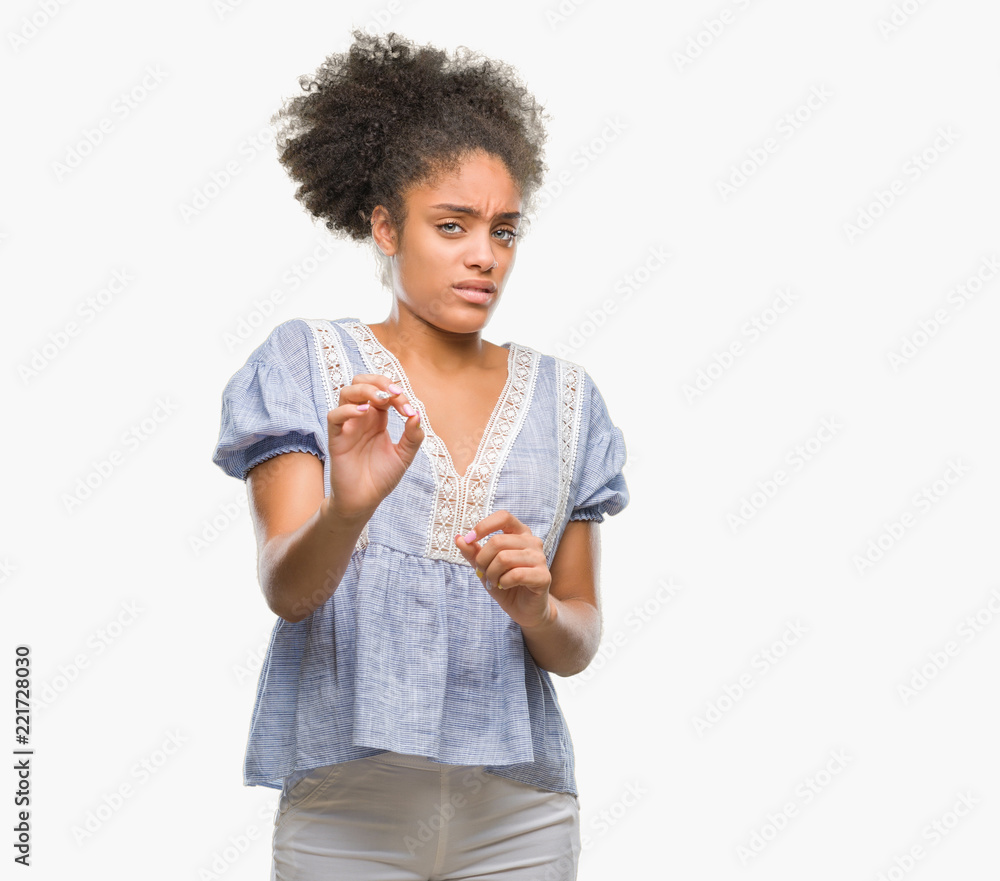 Young afro american woman over isolated background disgusted expression, displeased and fearful doing disgust face because aversion reaction. With hands raised. Annoying concept. Young afro american woman over isolated background disgusted expression, displeased and fearful doing disgust face because aversion reaction. With hands raised. Annoying concept.