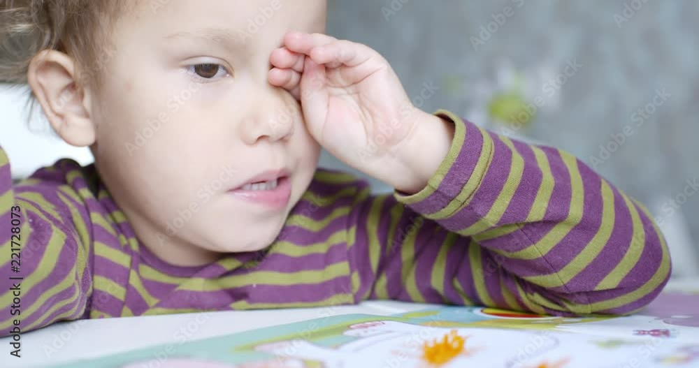 Small child with a wistful face that draws in the album Small child with a wistful face that draws in the album