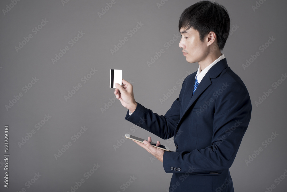 Business man is holding credit card and tablet , Shopping online concept Business man is holding credit card and tablet , Shopping online concept